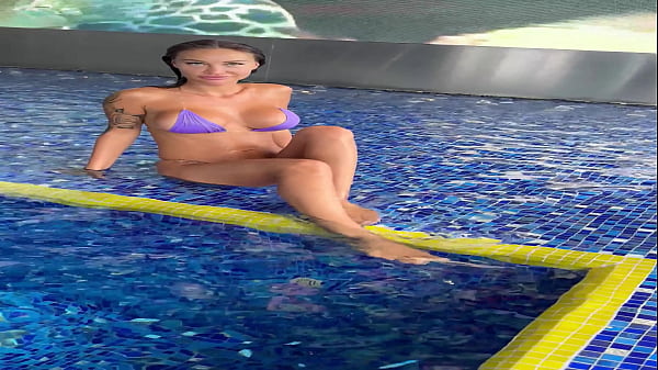 Monika Fox In Purple Bikini Swims In Pool & Poses By Window Against Background Of City (Free)